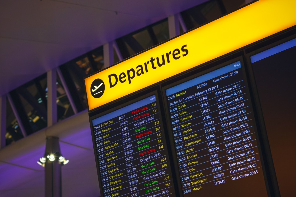 London, UK - August 12, 2018 - Departure board displaying time, destination cities and gate information in London Heathrow airport