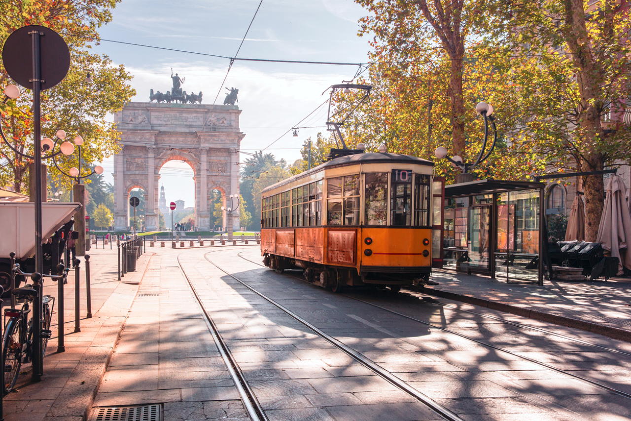 A vintage tram travels the streets of Milan